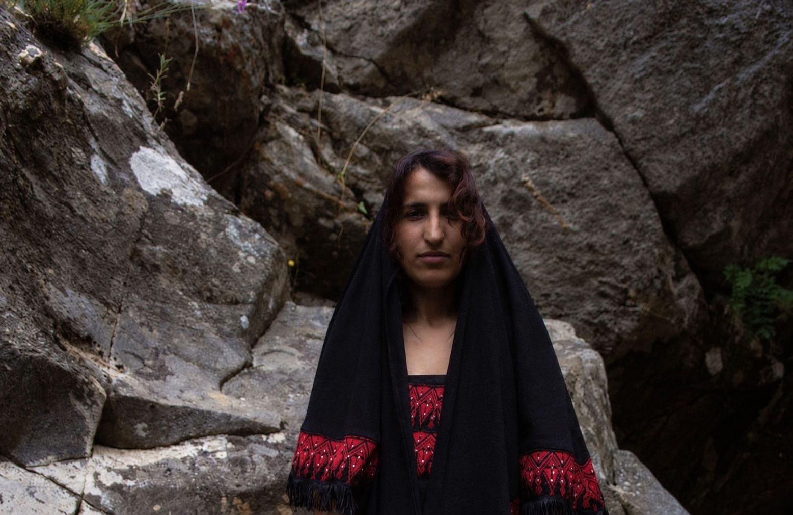 Haneen Sabbah outdoors wearing a black shawl with red embroidery